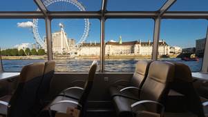 London Eye with blues skies from inside the boat